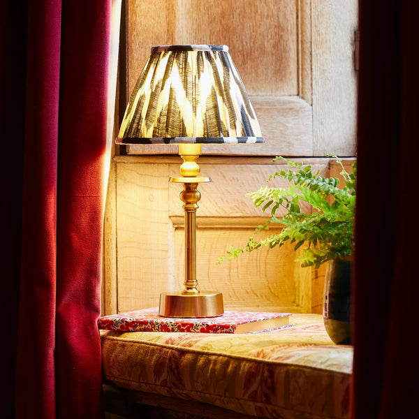 Black and white ikat shade on a rechargeable brass table lamp
