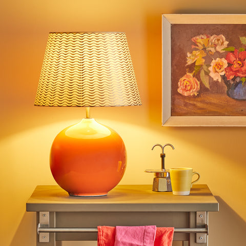 statement orange table lamp on a desk in a kitchen